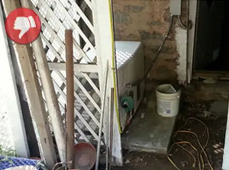 Ridiculously bad install Generator wedged into a corner by a doorway.