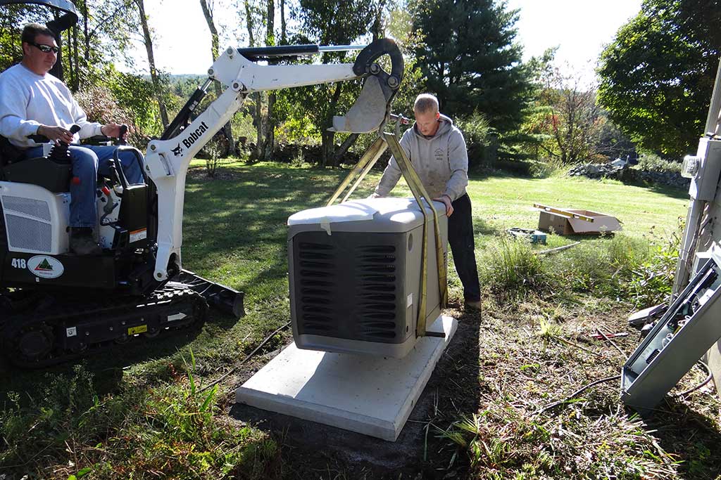 Lowering Generator on Concrete Pad Gen Plus technician lowering generator onto pad